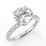 Diana Round cut lab diamond engagement ring with four prongs and a french pave band