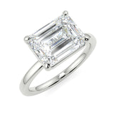 East-West Emerald lab diamond engagement ring with four prongs and plain band