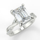 Elaine Emerald lab diamond engagement ring. Four prongs, tiger claws with a twisted band and cathedral setting. French pave set diamond gallery and french pave set diamond brigde.