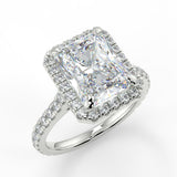 Single seamless halo design for an elongated radiant cut lab created diamond resting atop a single cathedral row. Diamond pave band.