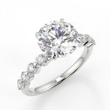 Raina Round cut lab diamond engagement ring with round accent stone and four prongs.