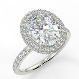 Raquel Oval lab diamond engagement ring. Non-cathedral, double edge seamless halo, single row French pave setting