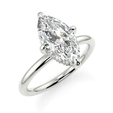 A silver engagement ring with a marquise-shaped lab created colorless centre stone, set in a full cut round brilliant lab grown diamond setting with a reverse halo.