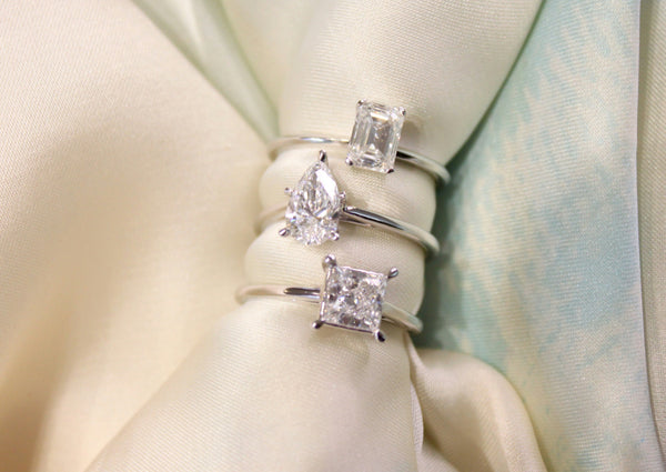 A stunning stack of solitaire diamond engagement rings in white gold