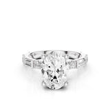 Diamond ring with a large central gemstone and smaller stones on a white background