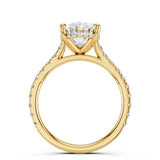 Gold ring with a large diamond and smaller diamonds on the band against a white background