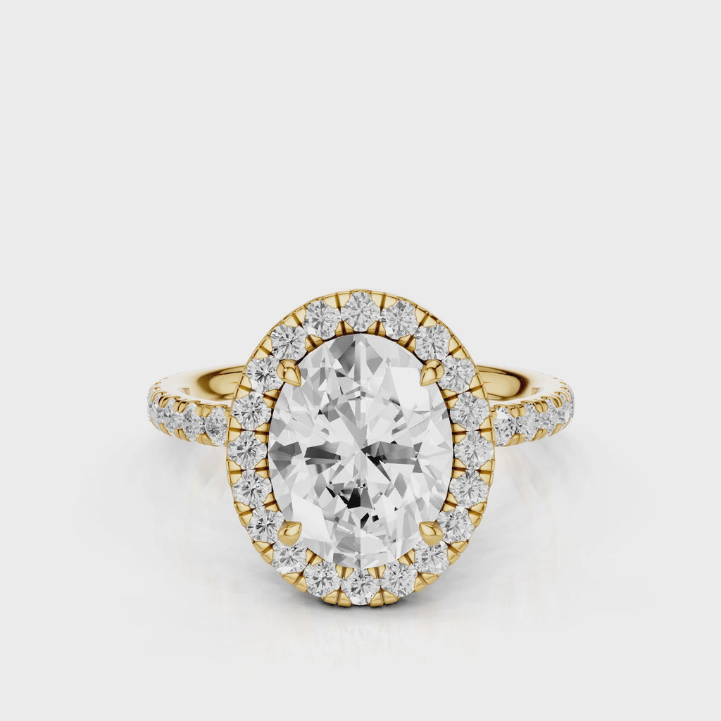 Raquel Oval lab diamond engagement ring. Non-cathedral, double edge seamless halo, single row French pave setting Yellow Gold
