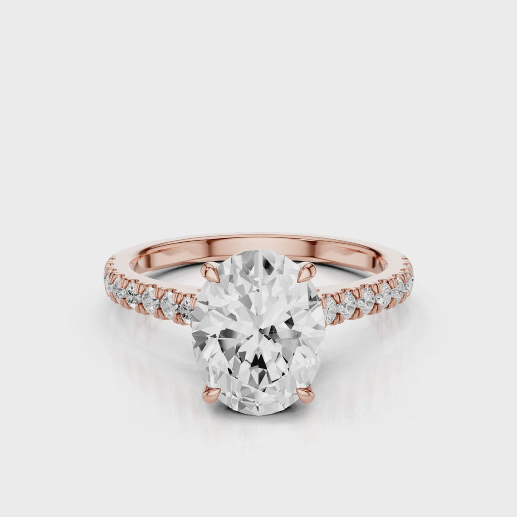 Dantella Oval lab diamond engagement ring with four prongs. Reverse seamless halo, cathedral, single row diamond band with floral basket design. Rose Gold