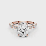 Dantella Oval lab diamond engagement ring with four prongs. Reverse seamless halo, cathedral, single row diamond band with floral basket design. Rose Gold