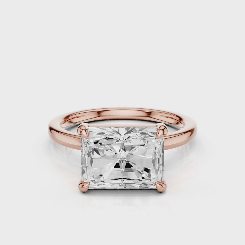 Elongated Radiant lab diamond engagement ring with east-west setting anf plain rounded band. Four prongs.  video  Rose Gold