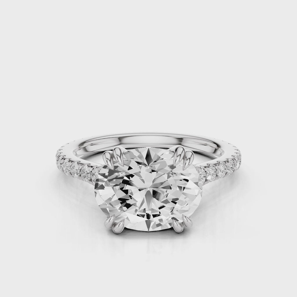 Nailah Oval lab diamond engagement ring in east west setting and tiger claw prongs and a french pave band video White Gold