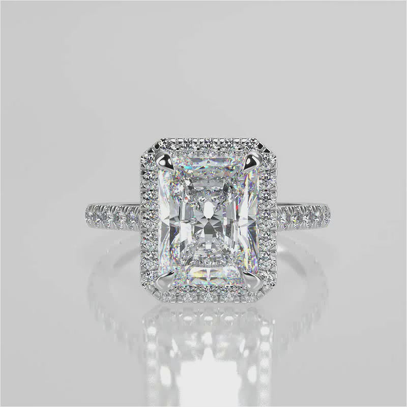 Single seamless halo design for an elongated radiant cut lab created diamond resting atop a single cathedral row. Diamond pave band video 