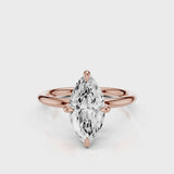A silver engagement ring with a marquise-shaped lab created colorless centre stone, set in a full cut round brilliant lab grown diamond setting with a reverse halo video  Rose Gold