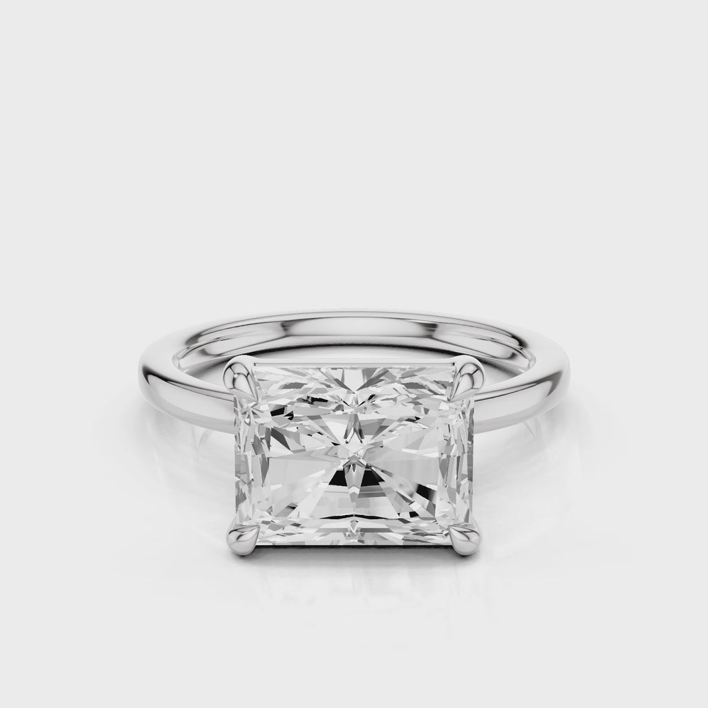 Elongated Radiant lab diamond engagement ring with east-west setting anf plain rounded band. Four prongs.  video White Gold
