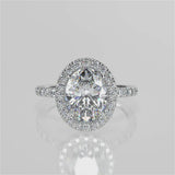 Jazlyn Oval lab diamond engagement ring. Non-cathedral, seamless halo, single row French pave setting band