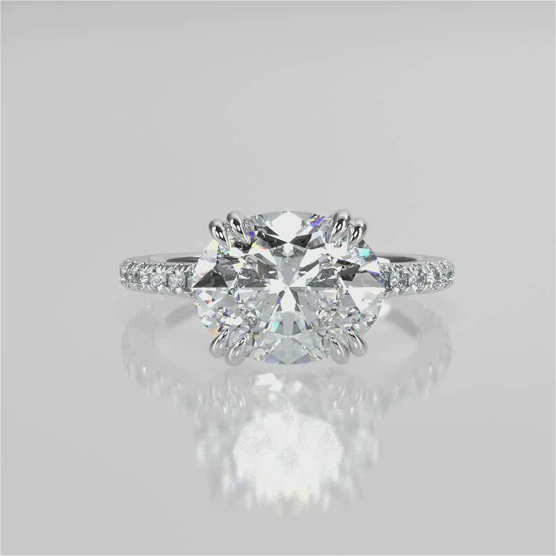 Nailah Oval lab diamond engagement ring in east west setting and tiger claw prongs and a french pave band video 