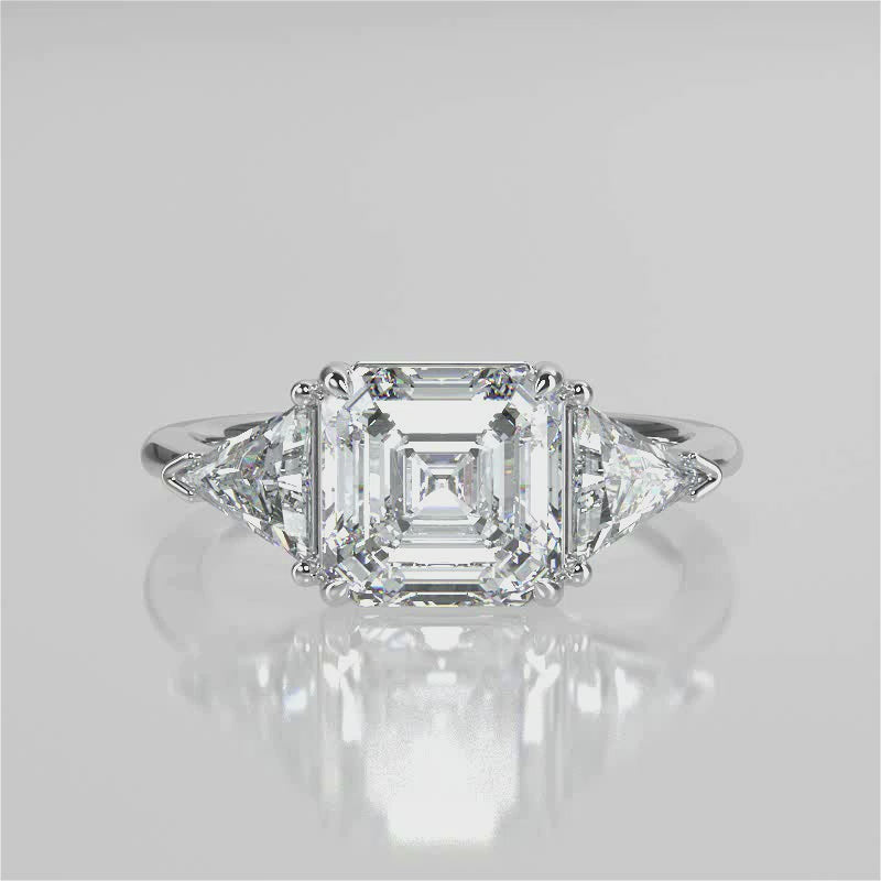 Nirvana Assher  Lab diamond engagement ring with three prongs triangle side stones with gallery video 
