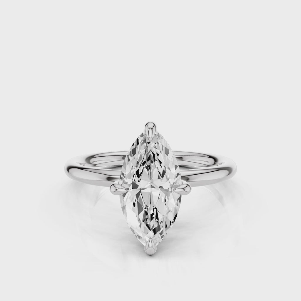 A silver engagement ring with a marquise-shaped lab created colorless centre stone, set in a full cut round brilliant lab grown diamond setting with a reverse halo video  White Gold