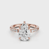 Maida Pear Diamond engagement ring with three accent round side stones on band Rose gold