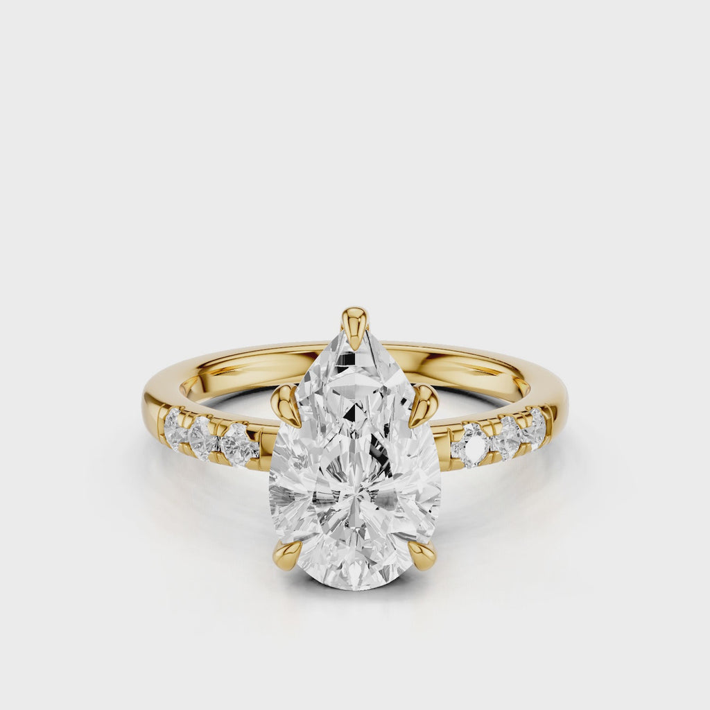 Maida Pear Diamond engagement ring with three accent round side stones on band yellow gold