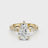 Maida Pear Diamond engagement ring with three accent round side stones on band yellow gold