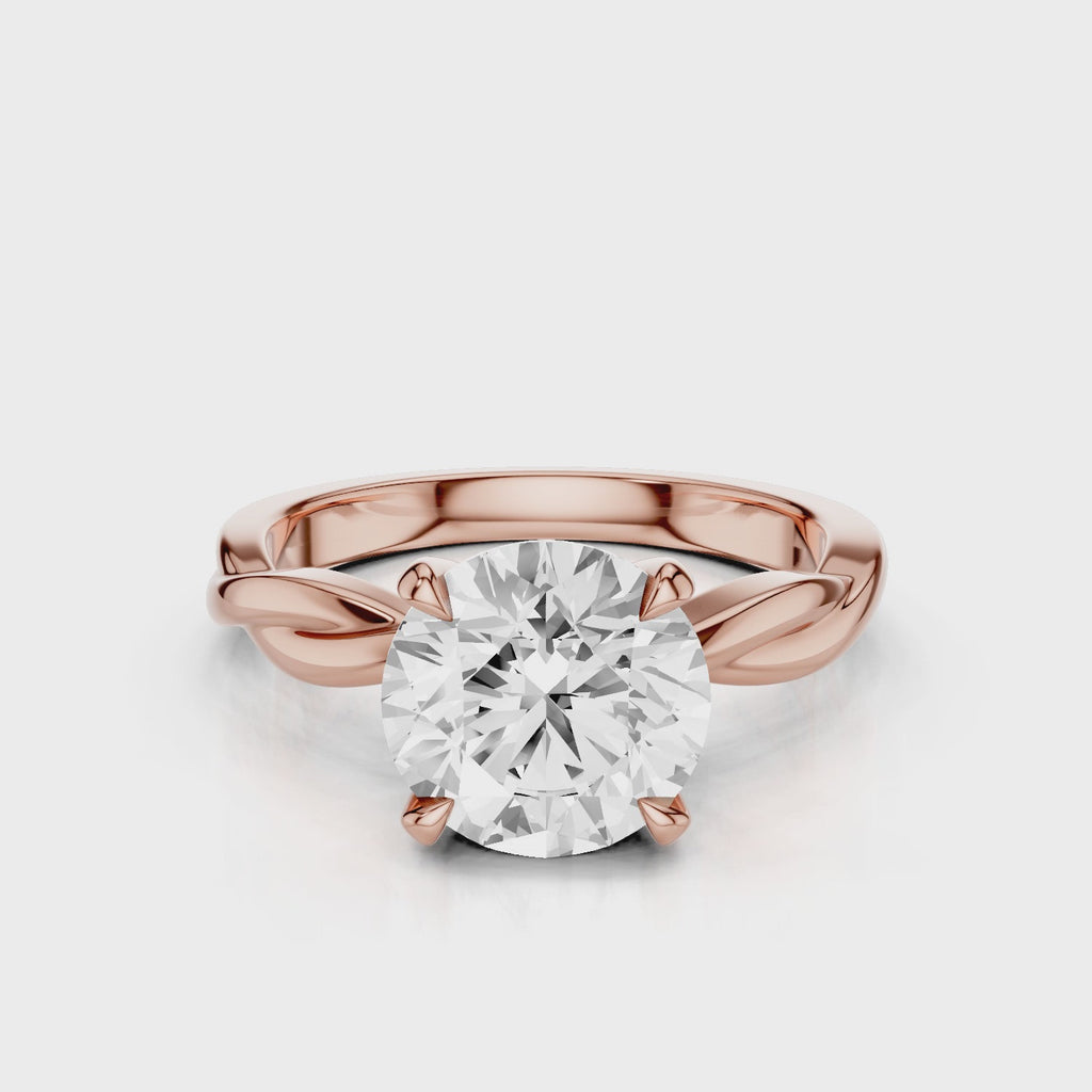 A twisted vine engagement ring with a lab created diamond center stone set in a white gold band video Rose Gold