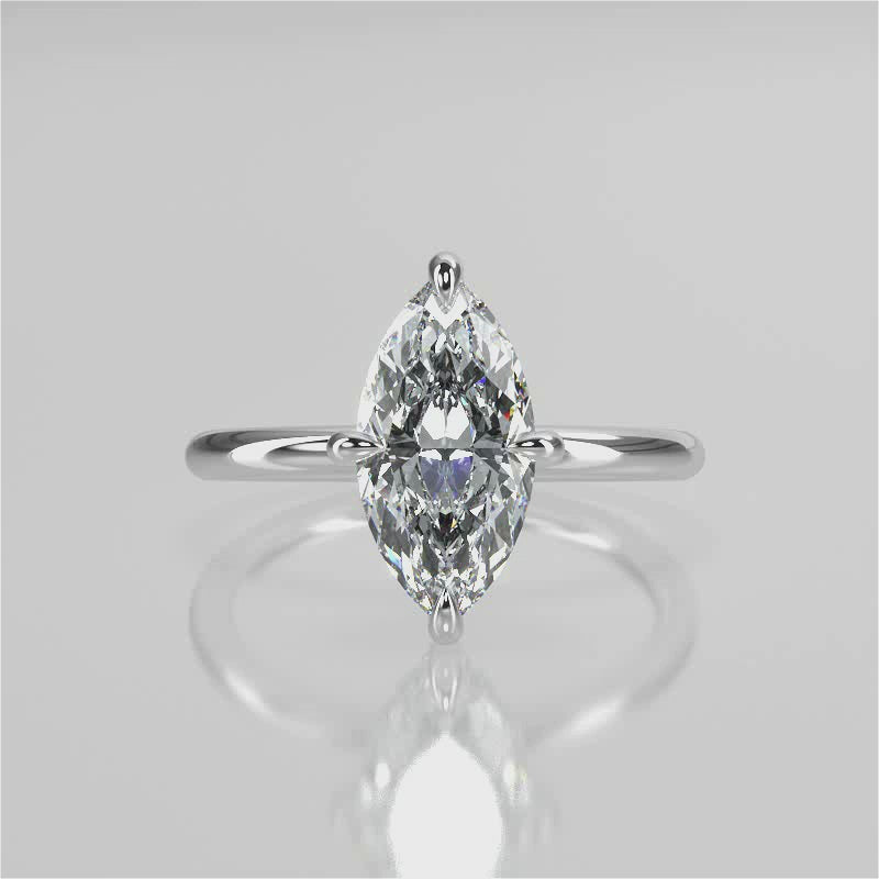 A silver engagement ring with a marquise-shaped lab created colorless centre stone, set in a full cut round brilliant lab grown diamond setting with a reverse halo video 
