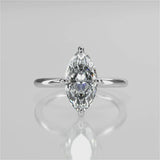 A silver engagement ring with a marquise-shaped lab created colorless centre stone, set in a full cut round brilliant lab grown diamond setting with a reverse halo video 