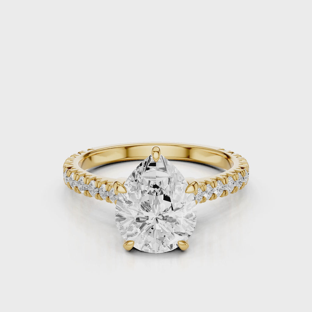 Hazel Pear lab diamon engagement ring with Cathedral shank and Single row French pave setting band video Yellow Gold