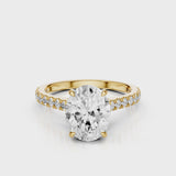 Dantella Oval lab diamond engagement ring with four prongs. Reverse seamless halo, cathedral, single row diamond band with floral basket design. Yellow Gold