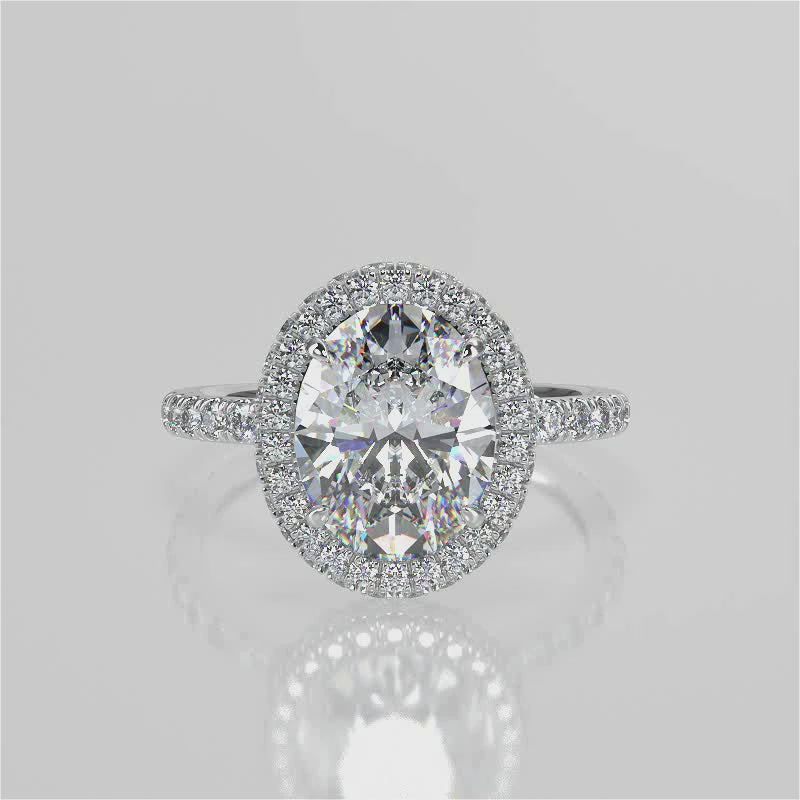 Raquel Oval lab diamond engagement ring. Non-cathedral, double edge seamless halo, single row French pave setting