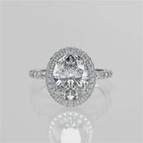 Raquel Oval lab diamond engagement ring. Non-cathedral, double edge seamless halo, single row French pave setting